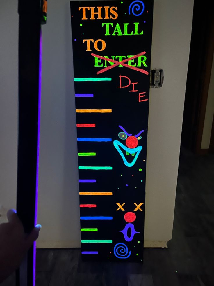 the door is decorated with neon colors and has an advertisement on it that says, this tall to enter die