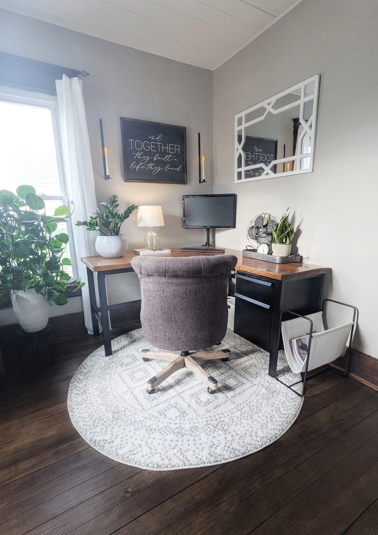 a chair sitting on top of a wooden floor in front of a desk with a computer