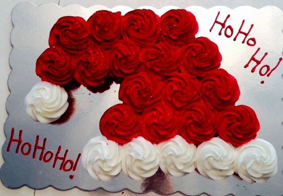 a red and white cake with frosting in the shape of a santa claus hat