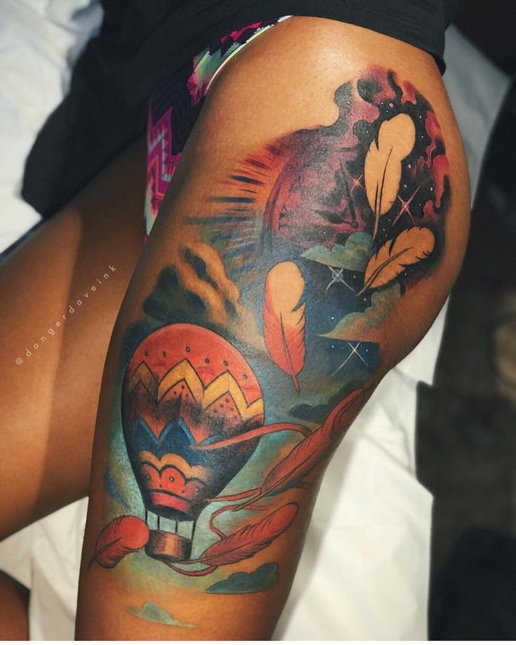 a woman's thigh with tattoos on it and an image of a hot air balloon