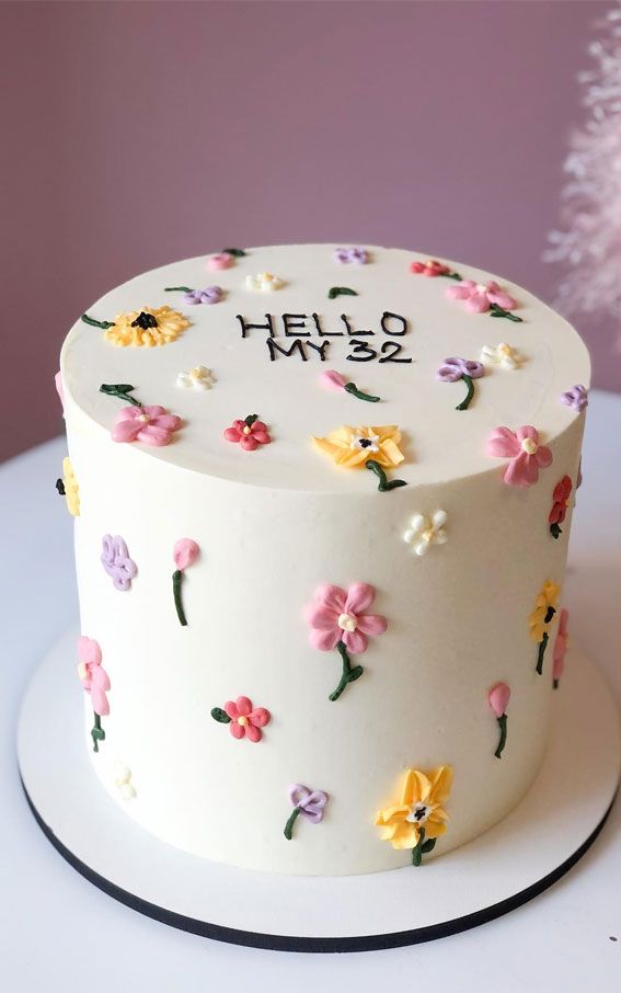 a white cake with colorful flowers on it