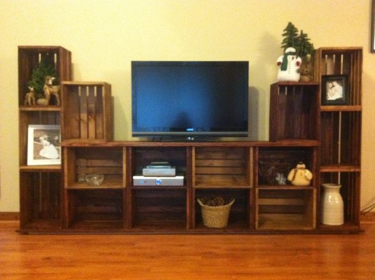 a flat screen tv sitting on top of a wooden shelf