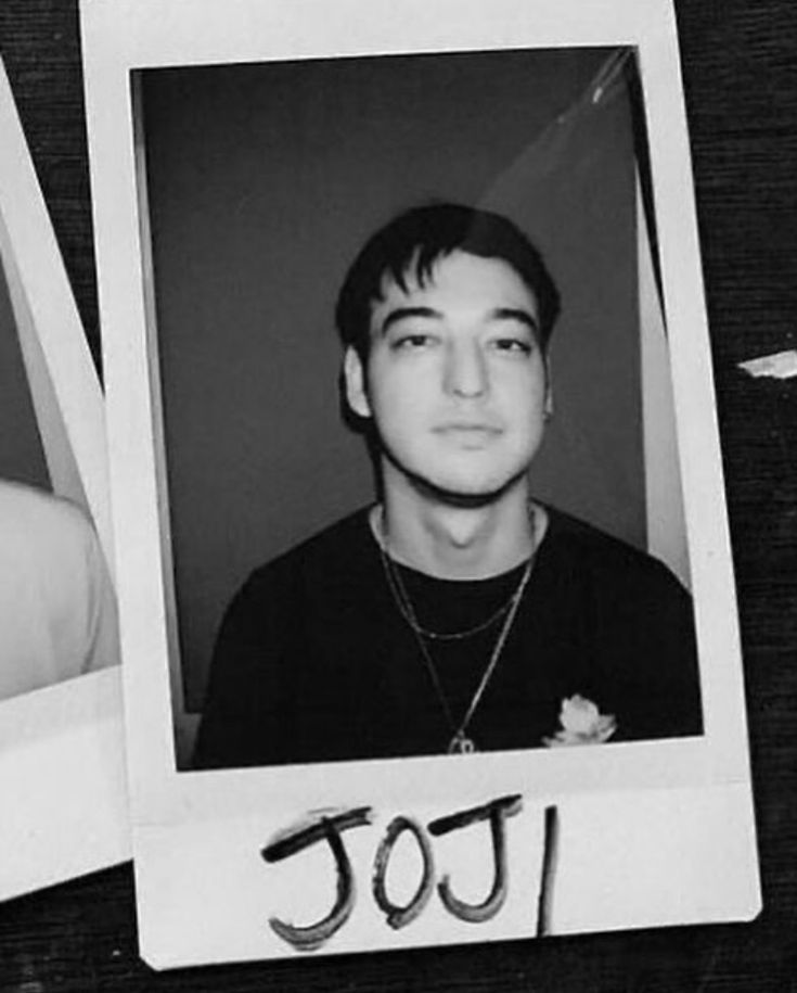 an old photo of a young man with the word too written on it