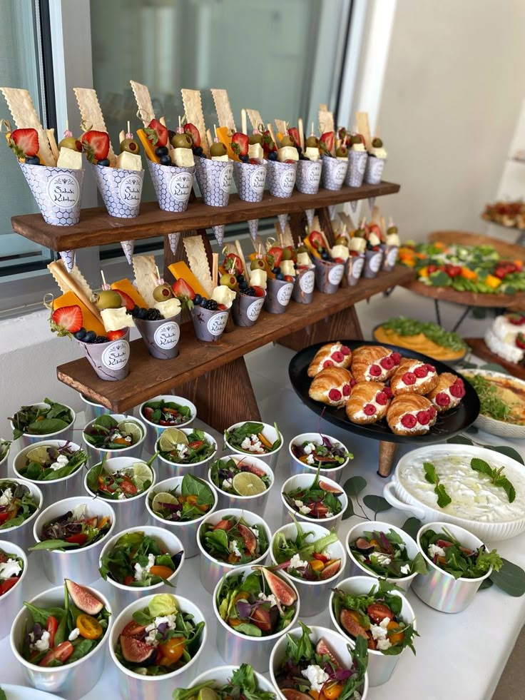 an assortment of food is displayed on a buffet table