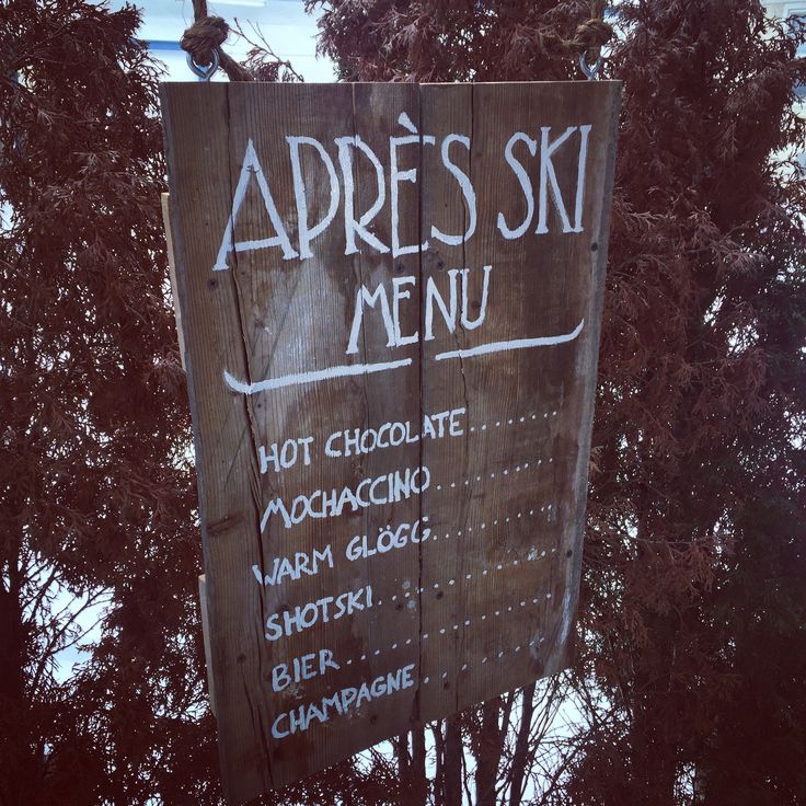 a wooden sign with writing on it that says appress ski menu and hot chocolate