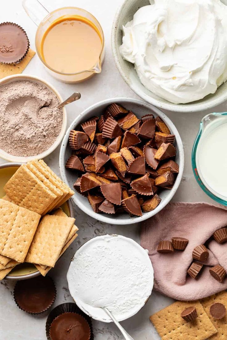 the ingredients to make s'mores are in bowls and on top of each other