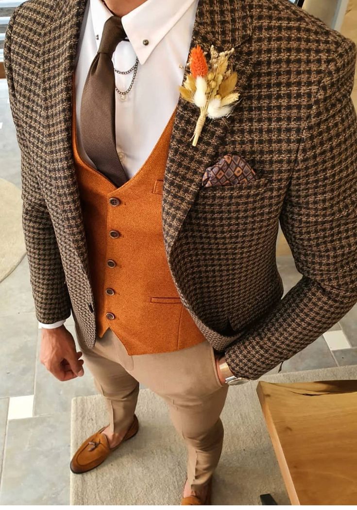 If you have brown and orange wedding color schemes, then this is mens fomal suit style for you! Here see a brown blazer paired with an orange vest and tan pants. Mens wedding fashion trends focus on colorful suits and unique suits. If this is your dream menswear look, visit our website and book an appointment with us at Giorgenti to have it custom made for you! . . Custom Suit NY, Custom Suit Queens, Custom Suit Long Island, Custom Suit NYC, Bespoke Suit New York, Bespoke Tailer Burnt Orange Mens Wedding Attire, Mens Brown Tuxedo Wedding, Mens Brown Wedding Attire, Brown Men’s Wedding Suit, Unique Suits For Men Wedding, Two Tone Suit Men Wedding, Mens Wedding Suits 2023, Mens Wear Wedding Unique, Mens Suits Ideas