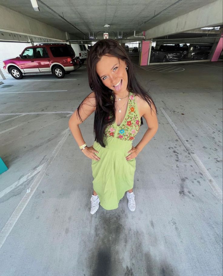 a woman standing in an empty parking garage