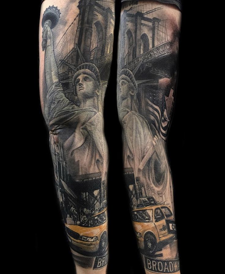 a man's legs with tattoos on them and an image of the statue of liberty