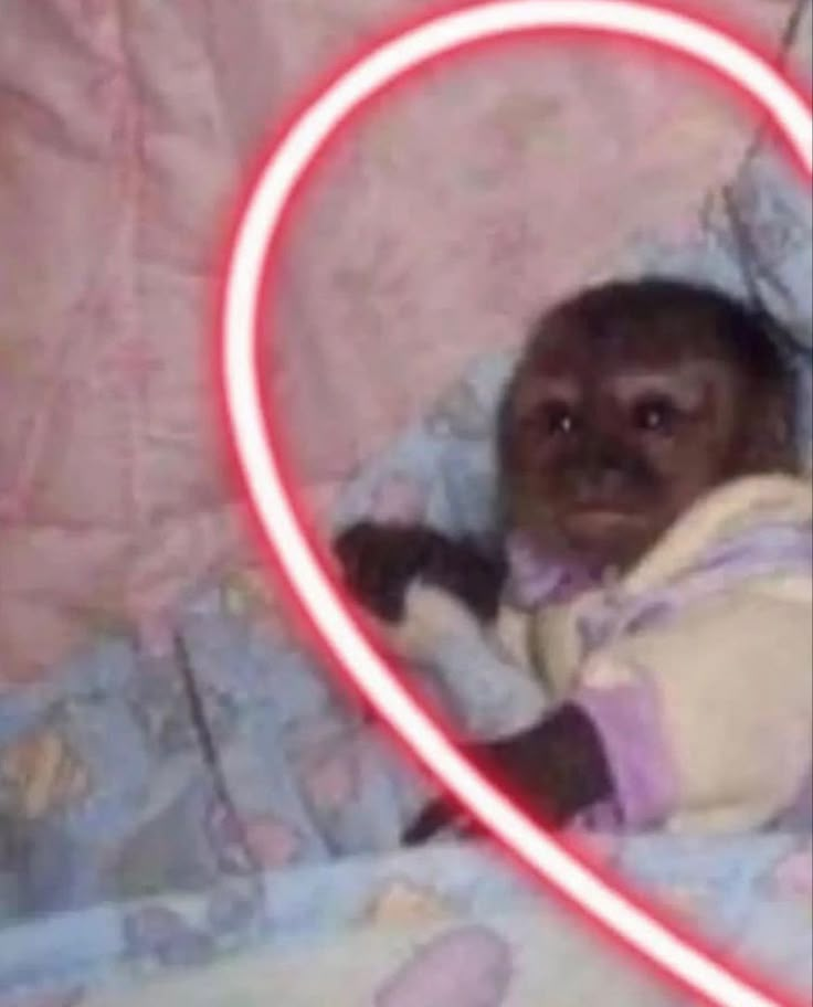 a baby in a crib with a heart - shaped light up frame around it