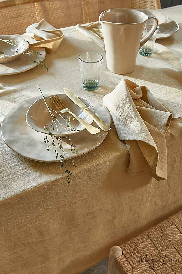 the table is set with plates, silverware and napkins for two people to eat