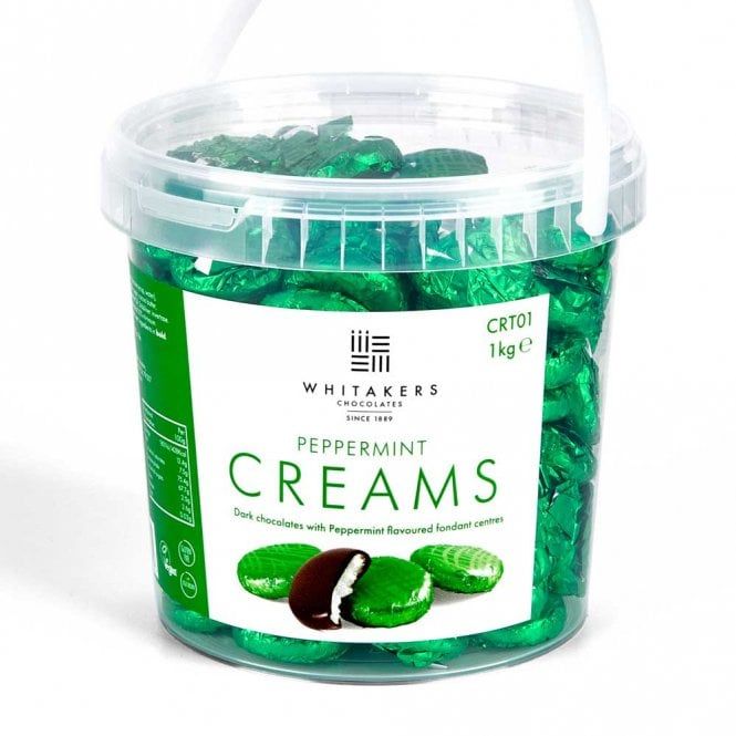 a tub filled with green candy sitting on top of a white table