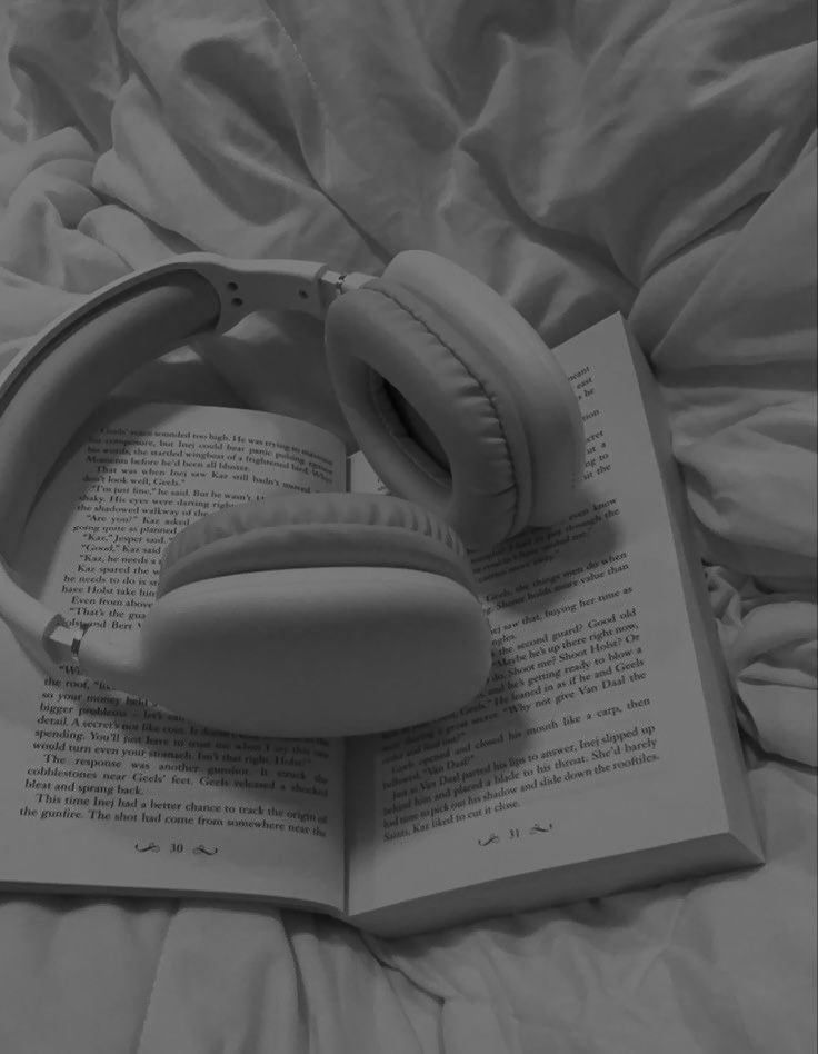 an open book with headphones on top of it