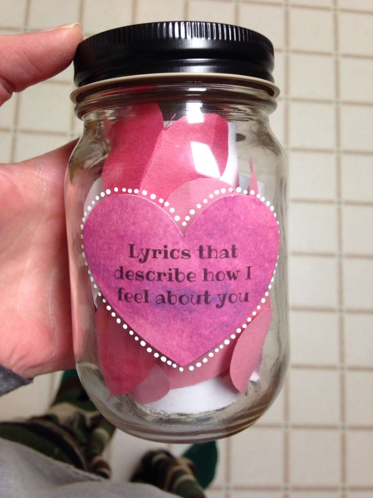 a person holding a jar filled with pink paper hearts and saying it's that describe how i feel about you