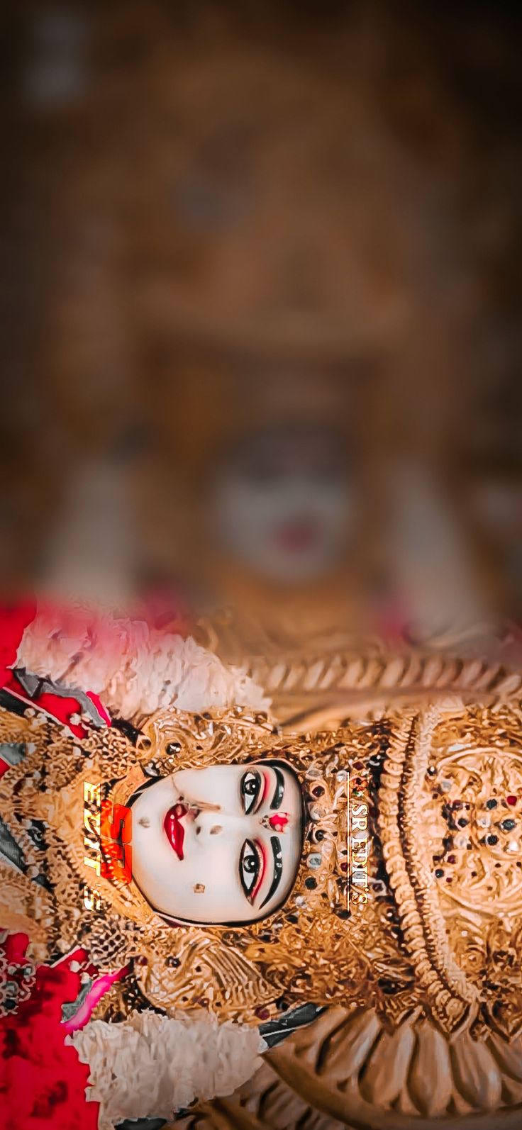 an ornately decorated doll sitting on top of a table