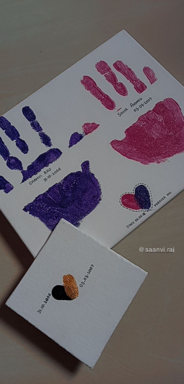 two handprints with different shapes and colors on them, one is pink, the other is purple