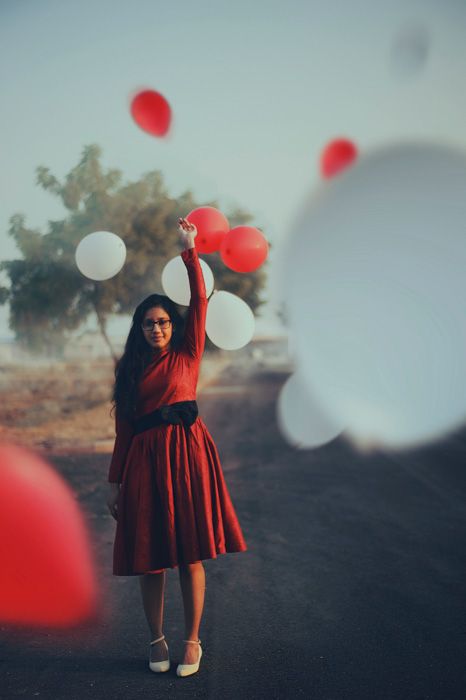 a woman in a red dress is holding up balloons with the caption, there's 1 bloods will change your business