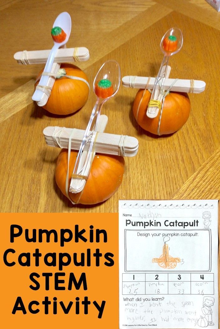 three pumpkins with toothbrushes attached to them on top of a wooden table