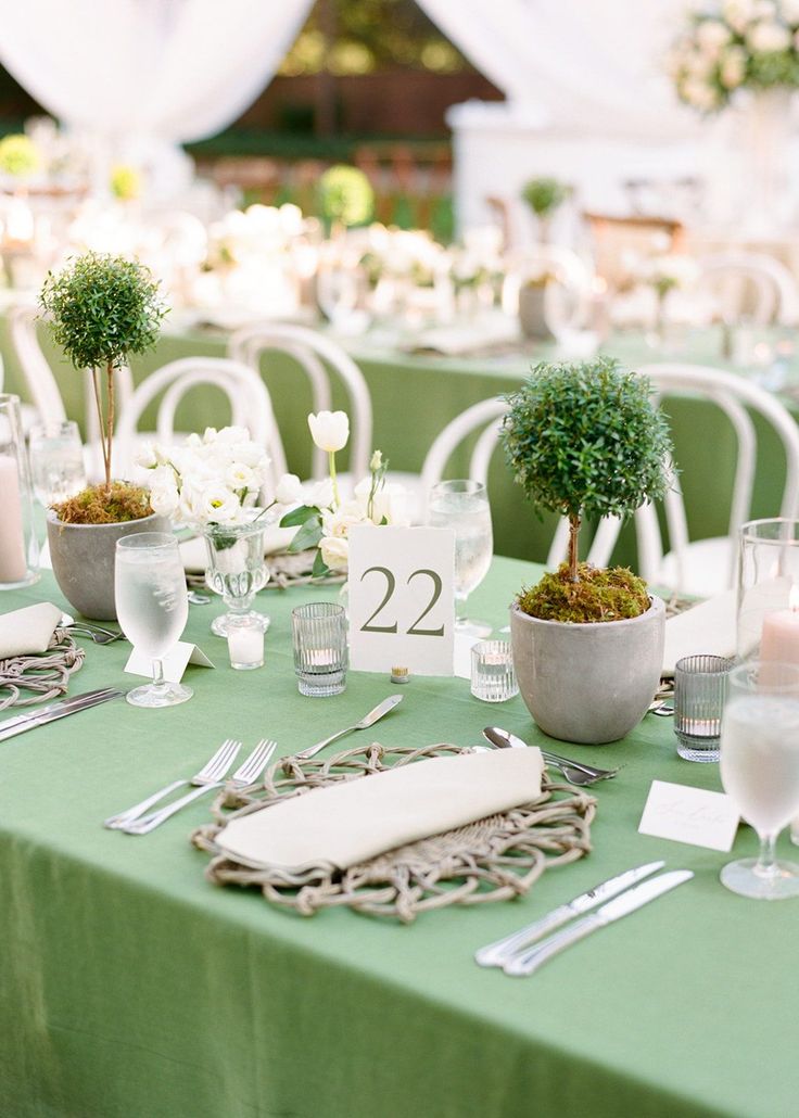 the table is set with silverware and place settings for guests to sit down at