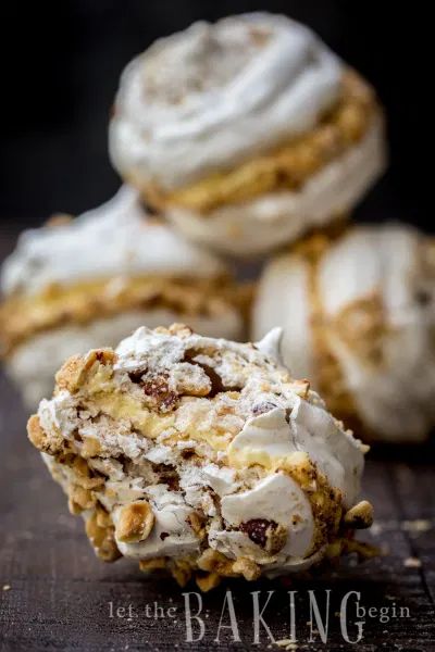 some food that is on top of a wooden table and has icing in it