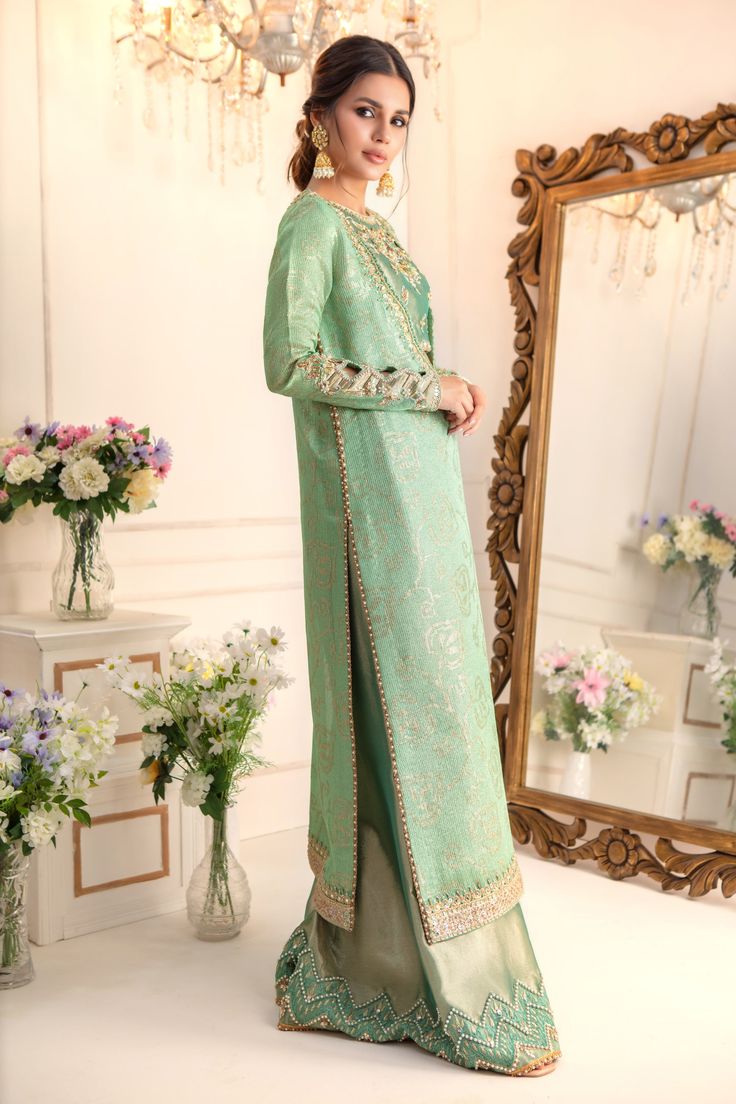 Add a touch of drama & elegance to your wardrobe this wedding season with our stylish ensemble, flowing silhouette paired with zardozi embroidered Blouse & dhaka pants for elongated and sleek look. Stunning embroidered dupatta with pearl & zardozi motifs finishes the look. Shirt & Dupatta Fabric: Pure Embroidered Maysuri NetDhaka Pant & Choli Fabric: Pure soft TissueColor: Caribbean Green This outfit is only available in Custom size, once order is placed design team will contact you for measurem Zardozi Motifs, Designer Outfit, Embroidered Dupatta, Pakistani Designers, Indian Designer, Indian Designer Wear, Sleek Look, Designer Wear, Embroidered Blouse