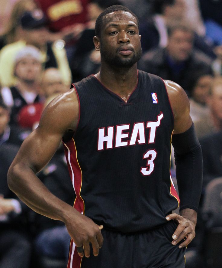 a basketball player standing in front of a crowd