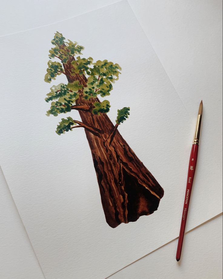 a drawing of a tree on paper next to a pencil