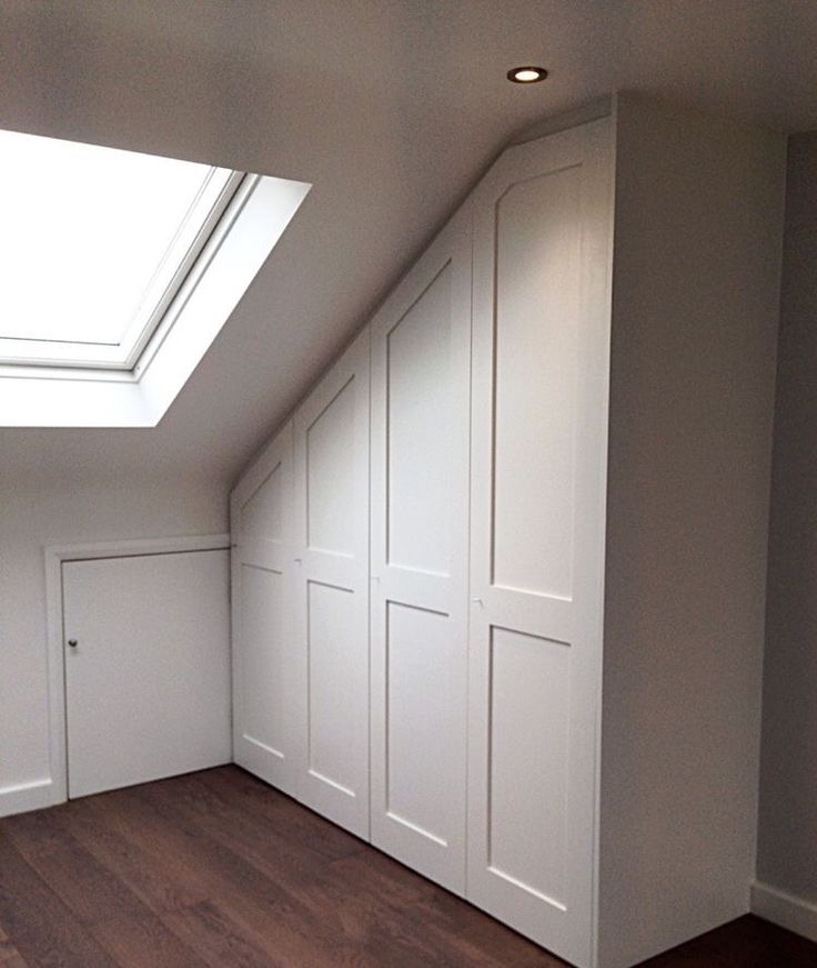 an empty room with white walls and wooden floors