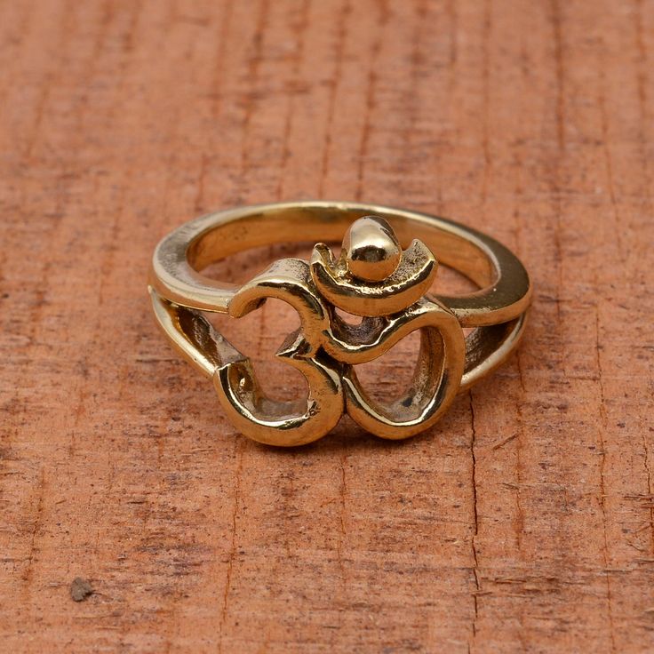 "Om Ring, 18k Gold Ring, Ohm Ring, Designer Silver Ring, Vintage Ring, Dainty Ring, Handmade Ring, Meditation Ring, Religious Ring, Yoga Ring  Material :- Silver,Brass,Gold,Rose Gold Plated ❥ Add this beautiful one little thing of galactic shine to make you feel unique and to transform your lives. Perfect for any kind of outfit and every occasion. ❥ Customers' satisfaction is our biggest priority, please contact us with any questions/queries for future or existing orders, and we will do our best to make sure you are happy with your order. ❥Please make sure to add the correct address during check out. You can return your purchased item within 15 days after successful delivery. We offer a 100% \"Money Back Guarantee\" if you are not satisfied with your purchase. Return charges will be paid b Symbolic Brass Jewelry For Anniversary, Yellow Gold Brass Toe Stackable Rings, Hand Forged Brass Open Ring, Symbolic Hand Forged Open Ring, Spiritual Hand Forged Rings For Anniversary, Gold Brass Midi Rings For Anniversary, Hand Forged Open Symbolic Ring, Bronze Brass Rings For Anniversary, Anniversary Bronze Brass Ring