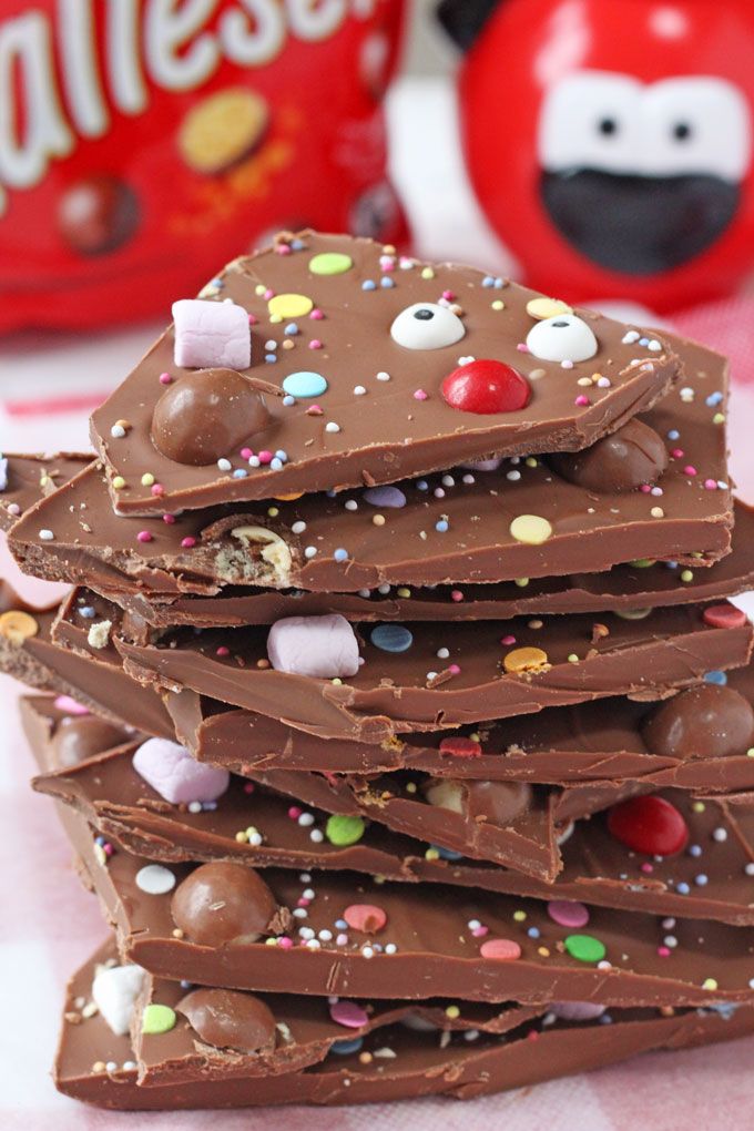 a stack of chocolate candy with sprinkles and candies