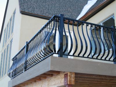 a balcony with metal railings and balconies on the side of a building