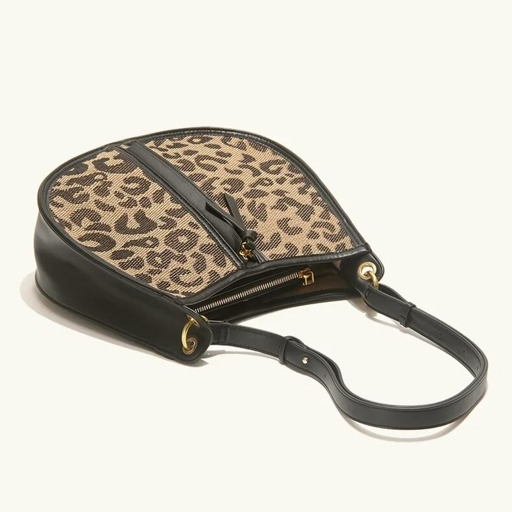 Upgrade Your Style with the Leopard Saddle Shoulder Bag Elevate your fashion game with our Leopard Saddle Shoulder Bag, crafted from premium microfiber leather for a luxurious feel. Designed for the modern woman, this bag combines functionality with trend-setting style, making it the perfect accessory for any occasion. Product Features Microfiber leather upper for durability and a sleek look Polyester lining material for added strength and resilience Zipper closure for secure storage of your essentials Bow decoration adds a touch of charm and femininity Spacious interior with an interior slot pocket for easy organization Available in classic Black or versatile Brown Benefits You'll Love Elevated Style: Stand out from the crowd with the chic leopard print design and sleek saddle shape of th Chic Saddle Bag With Removable Pouch And Double Handle, Chic Saddle Bag With Adjustable Strap For Shopping, Versatile Saddle Shoulder Bag With Detachable Handle, Trendy Bags With Detachable Strap And Coated Canvas, Trendy Saddle Bag With Detachable Strap For Shopping, Chic Saddle Bag With Detachable Handle For Everyday, Handheld Faux Leather Bucket Bag For Travel, Chic Large Capacity Saddle Shoulder Bag, Chic Large Capacity Saddle Bag For Shopping