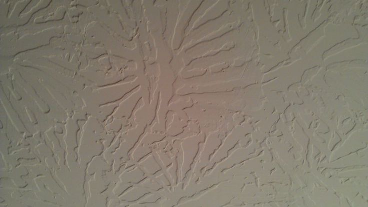 a bathroom wall with white paint on it