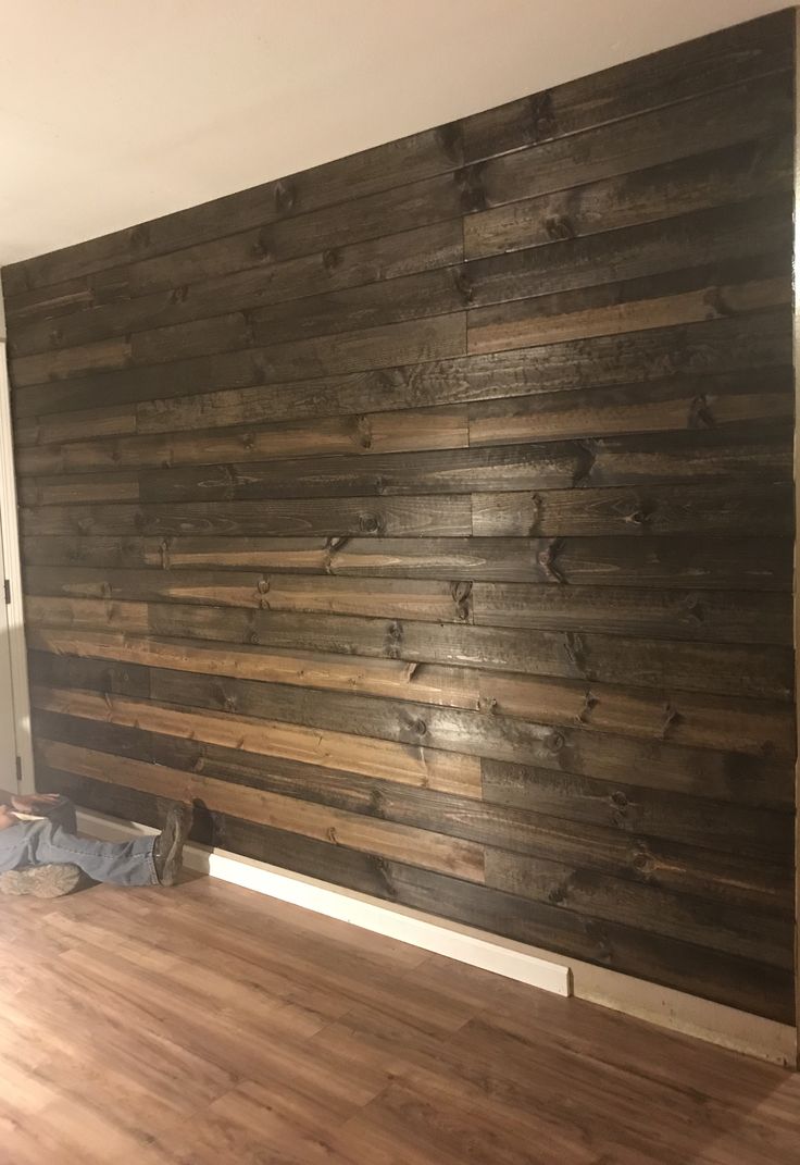 an empty room with wood paneling on the wall