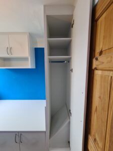 an empty kitchen with blue and white walls