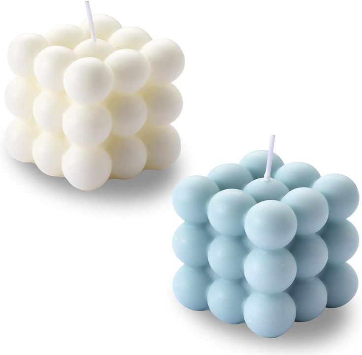 two candles with different shades of blue and white on the top one is shaped like grapes