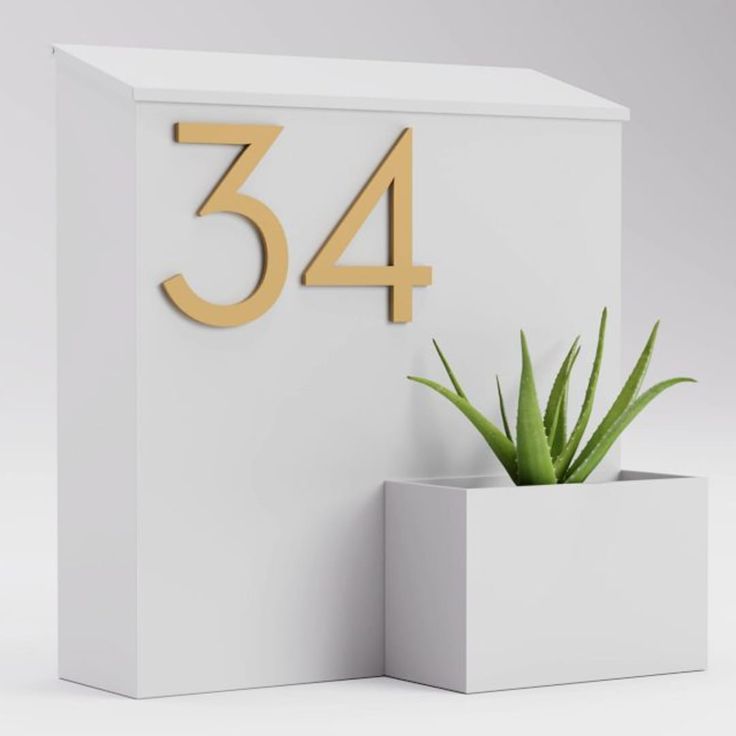 a white box with a plant in it and the number 34