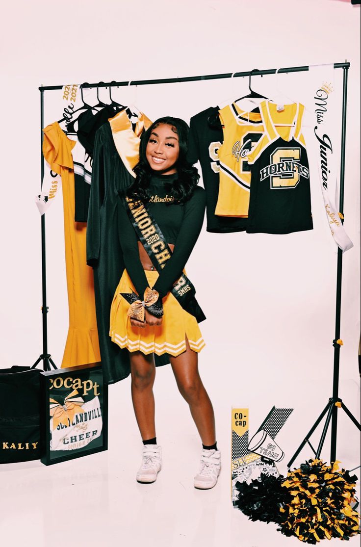 a woman standing in front of a display of shirts and cheerleader's gear