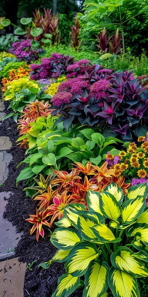 many different colored flowers in a garden