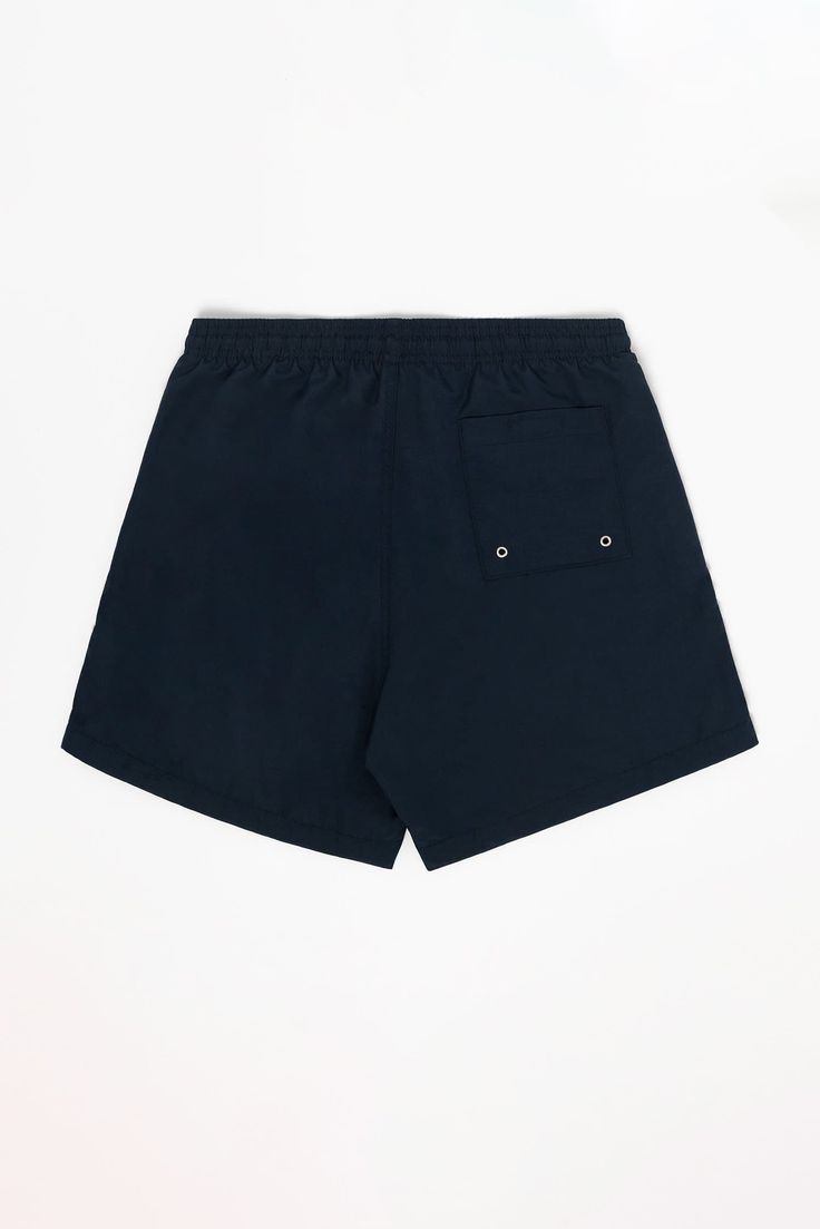 This classic cut men's swim trunk is fully lined with our comfort mesh liner. Unlike traditional swim trunks, our liner extends to the bottom of the shorts, which have a 4.5" inseam. This style features 2 deep side pockets and one back pocket with eyelets for drainage and a velcro seal so the shorts are functional in and outside of the pool. Also features a drawcord on the inside to adjust the waistband. Made in Los Angeles, Calif. Our experienced seamstresses earn an average up to $20 an hour o Navy Swim Trunks With Built-in Shorts For Vacation, Navy Swim Trunks With Built-in Shorts For Beach, Navy Swimwear With Built-in Shorts For Vacation, Navy Swimwear With Built-in Shorts, Relaxed Fit Swim Trunks With Built-in Shorts, Cotton Swim Trunks With Built-in Shorts For Pool, Summer Nylon Swim Trunks With Side Pockets, Relaxed Fit Nylon Swim Trunks With Side Pockets, Swim Trunks With Built-in Shorts Relaxed Fit