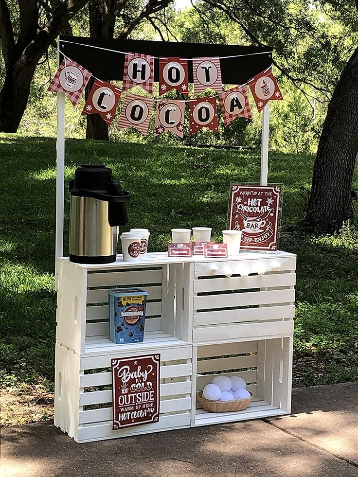 a hot chocolate stand on the side of a road with bunting flags and decorations