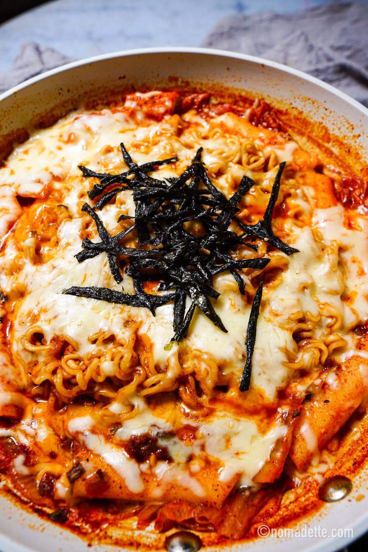 a white bowl filled with pasta and sauce