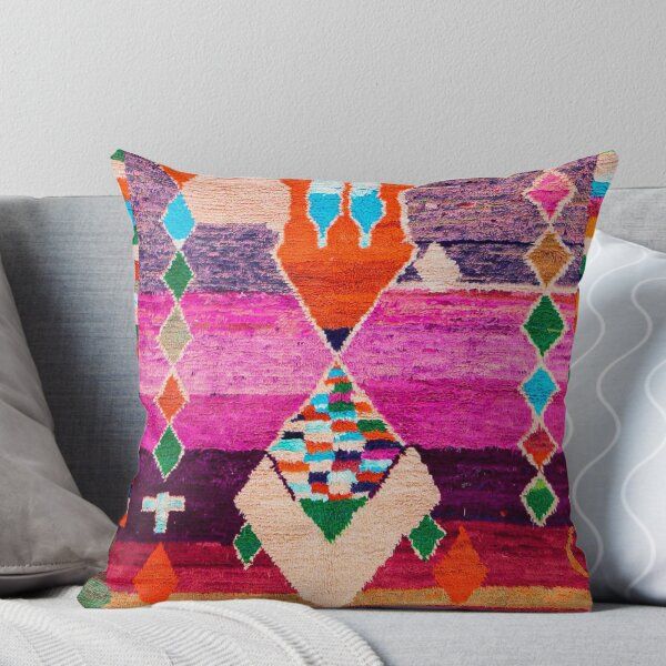 a colorful throw pillow on a couch