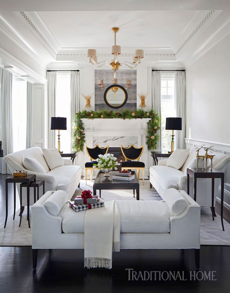 a living room filled with furniture and a fire place next to a white couch in front of a fireplace