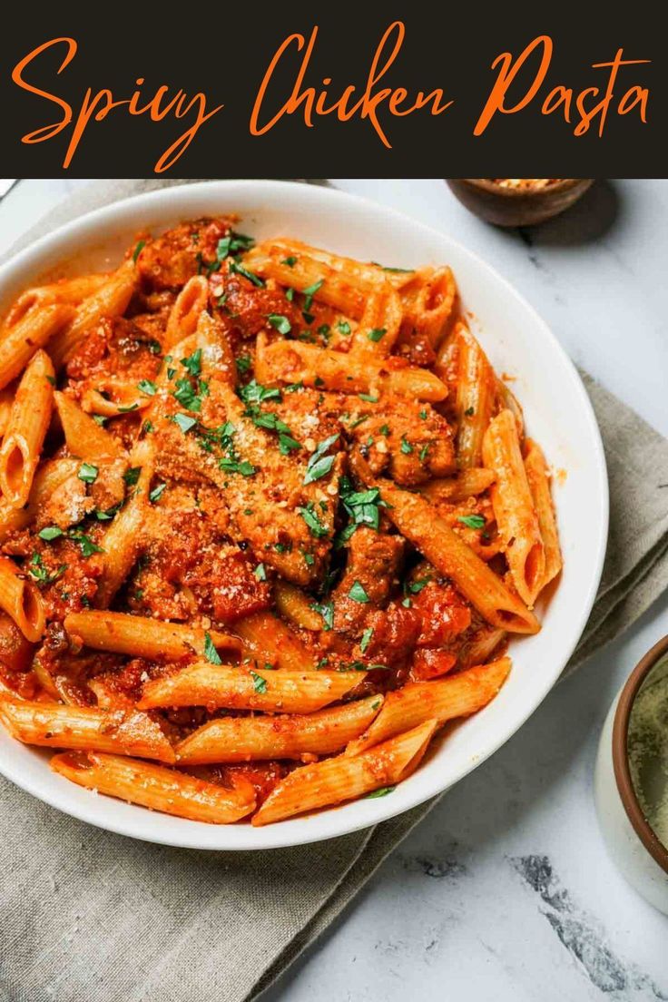 a bowl filled with pasta and sauce on top of a table