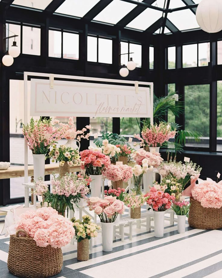 pink and white flowers are in vases on the table