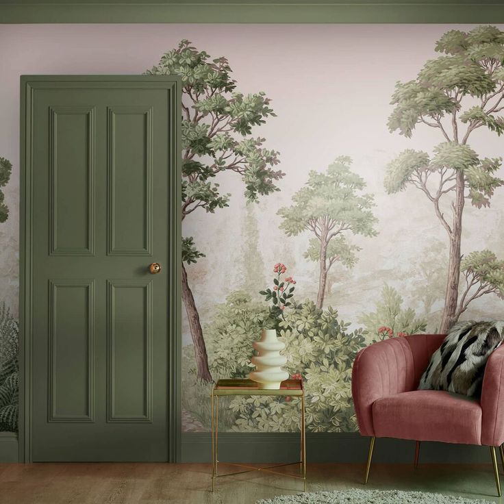 a living room with a pink chair next to a green door and wallpaper on the walls