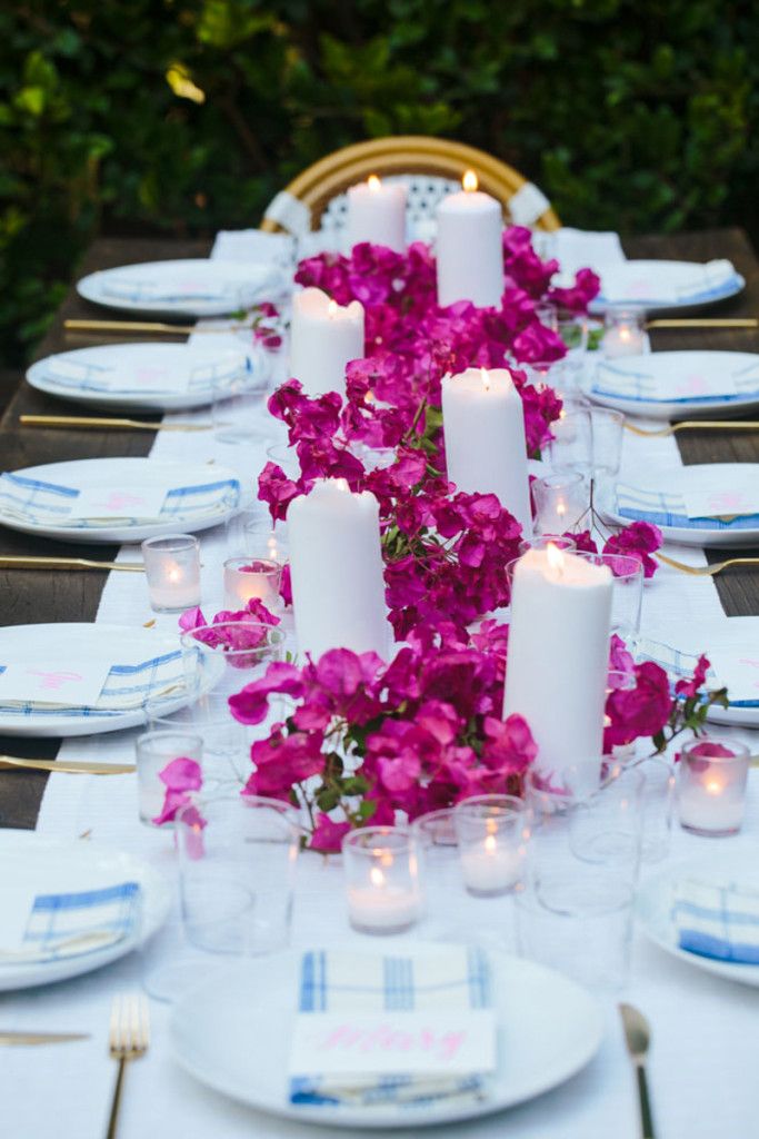 the table is set with candles and flowers