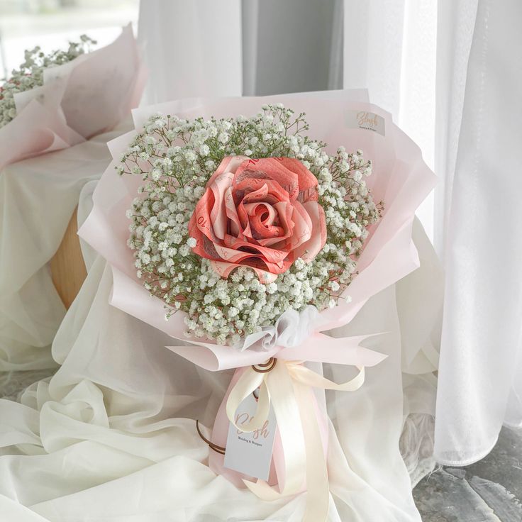 a bouquet of pink roses and baby's breath