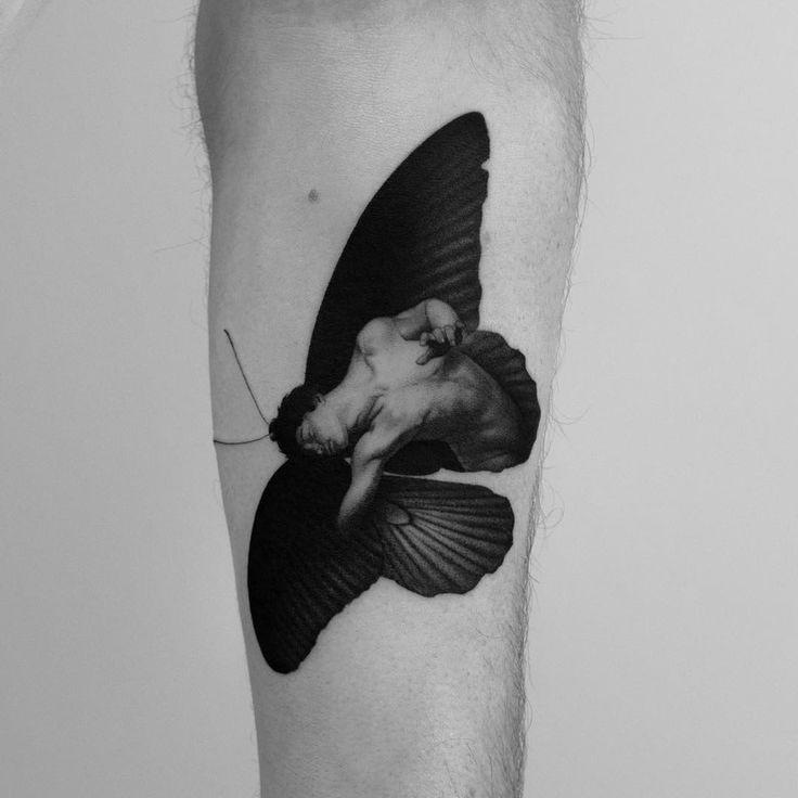 a black and white photo of a man's leg with a bird on it